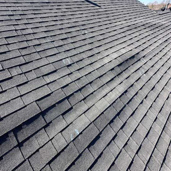 roof shingles bubbling and coming up due to bad installation and shingles not sealing