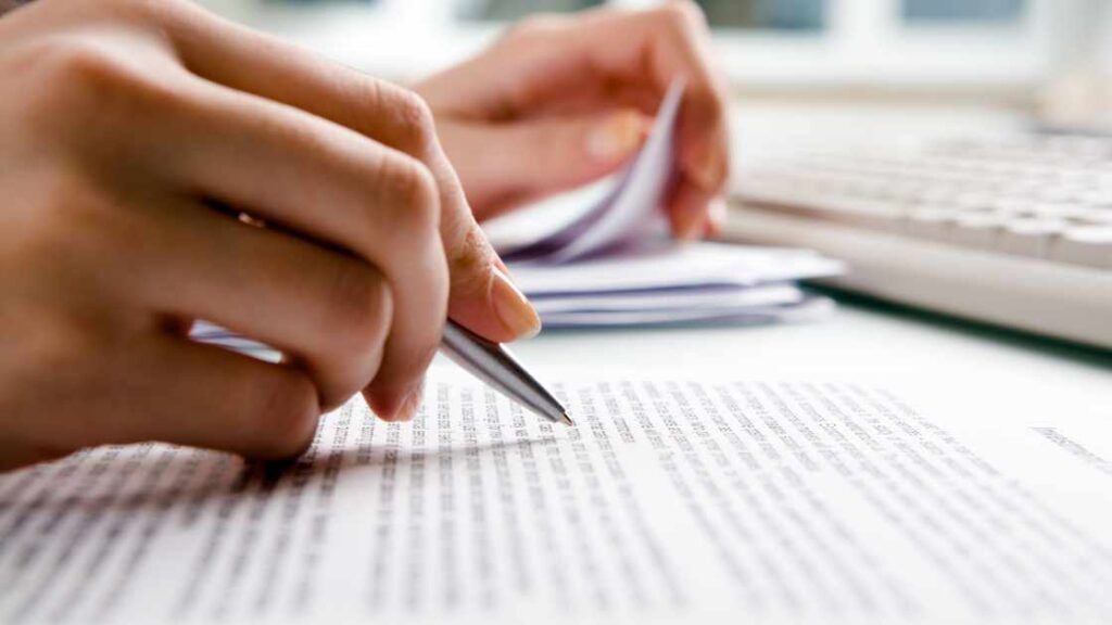 homeowner filing a storm damage claim with pen and paper