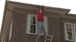 man hanging from roof gutters after not following roof safety tips