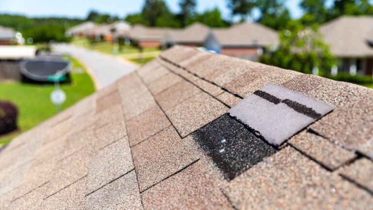 torn roof shingle from storm damage