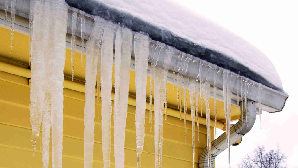 icicles hanging from roof and gutters causing winter roof repair