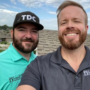 talk to a roofing expert roof inspectors on top of roof taking selfie