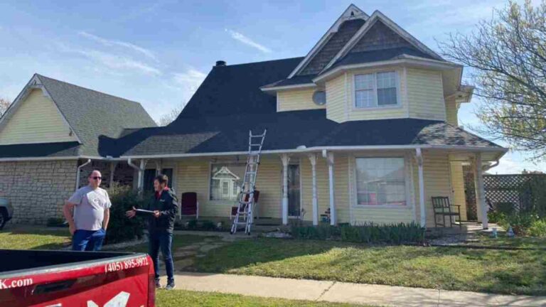 roofer with homeonwer in front yard explaining home repairs needed after hail storm