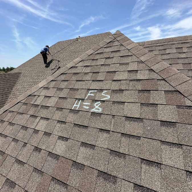 grey residential roof before hail damage repairs in Shawnee were made