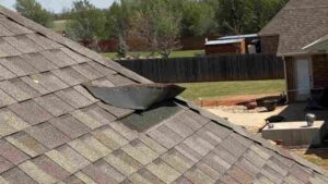 shingle missing form roof due to poor installation and homeowner choosing the cheapest roof option