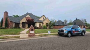 Triple Diamond Construction & Roofing company truck outside of home explaining roof inspection cost in OKC to homeowner while providing one for the residential home