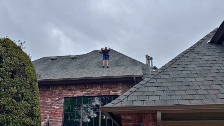roofer on top of home providing roof inspection after a storm in OKC