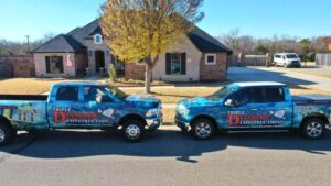 general contractor in Oklahoma City outside residential home telling homeowner what January home maintenance tasks to complete