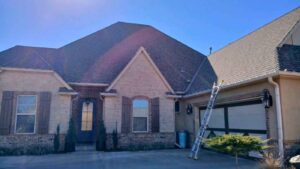 ladder up against residential home to give roof inspection and explain late winter roof problems OKC homeowers often miss