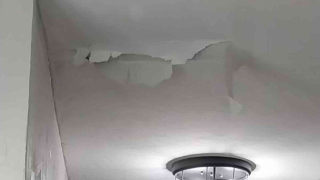 roof leak inside home coming through the ceiling and paint peeling back caused by roof hail damage