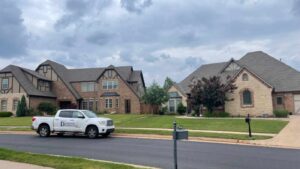 roofing company truck outside of home in Oklahoma City ready to explain roof insurance to homeowner