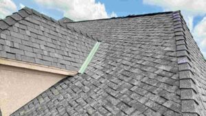 close up of roof damaged by hail found during inspection after homeowner decided to call a roofer or insurance first after a storm