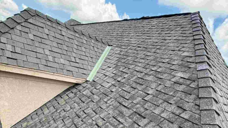 close up of roof damaged by hail found during inspection after homeowner decided to call a roofer or insurance first after a storm
