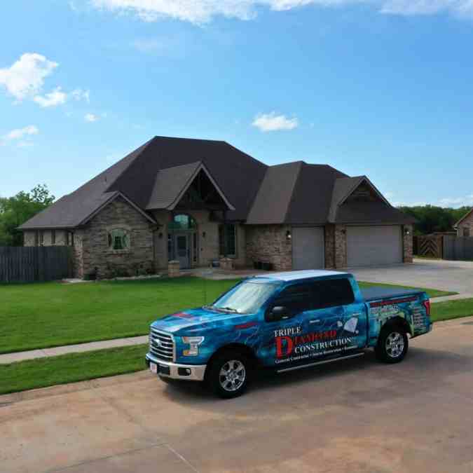 Triple Diamond Construction truck outside of residential home after roof was replaced due to hail damage repairs in Shawnee, OK