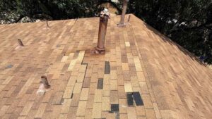 Roof in Moore, OK missing several shingles after wind storm showing why roofs in Moore take more damage from storms