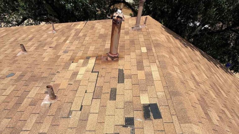 Roof in Moore, OK missing several shingles after wind storm showing why roofs in Moore take more damage from storms