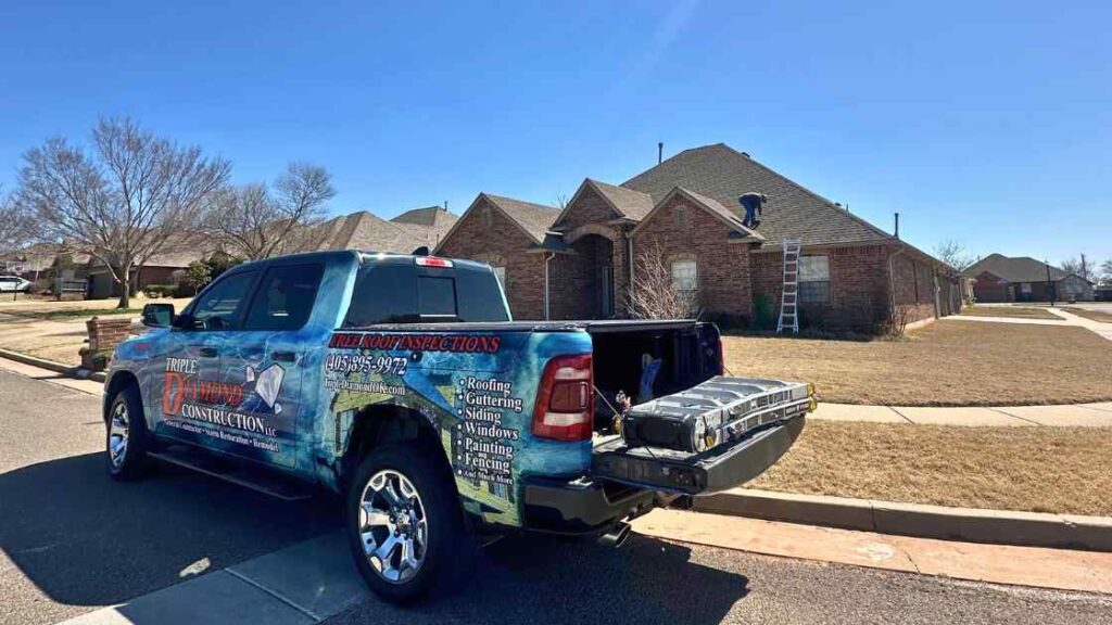 roofing company truck outside of home with contractor talking to homeowner about best roofs for Oklahoma homes