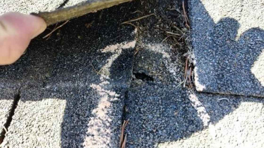 roofer showing hidden signs of hail damage on roof found during inspection in Oklahoma City