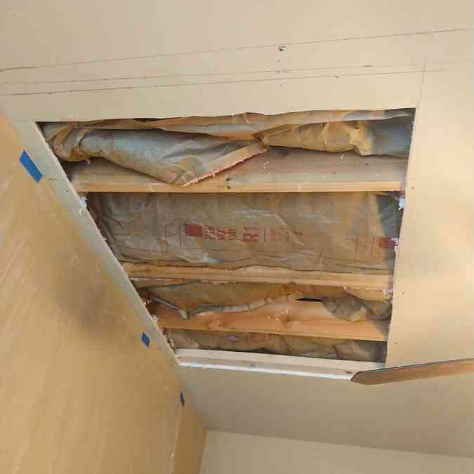 three foot by four foot of ceiling drywall cut out after roof leak