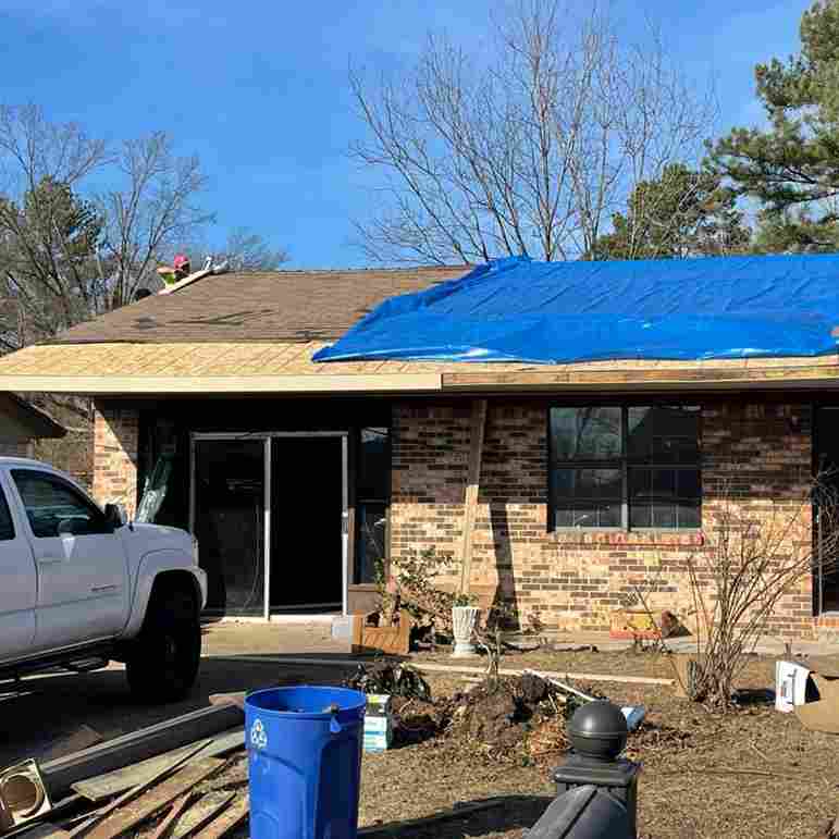 emergency storm damage repairs - tarp on roof