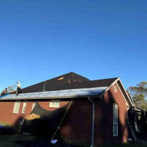 roofing crew on residential home completing full roof replacement in harrah ok