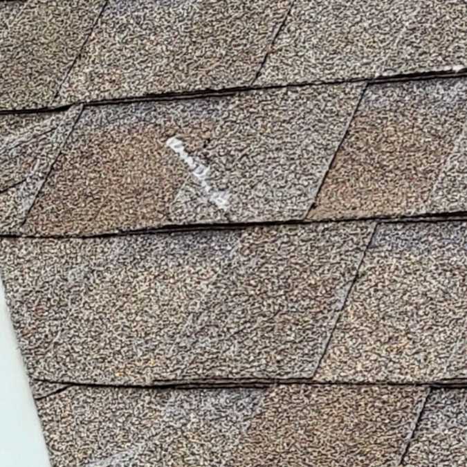 close up of hail impact mark on residential roof shingle in Choctaw, OK