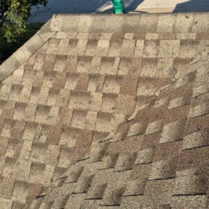 dents on roof shingle caused by hailstorm in Edmond, OK on September 24, 2024