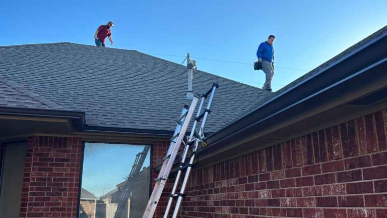 roofers teaching homeowner how to locate a roof leak while on top of roof