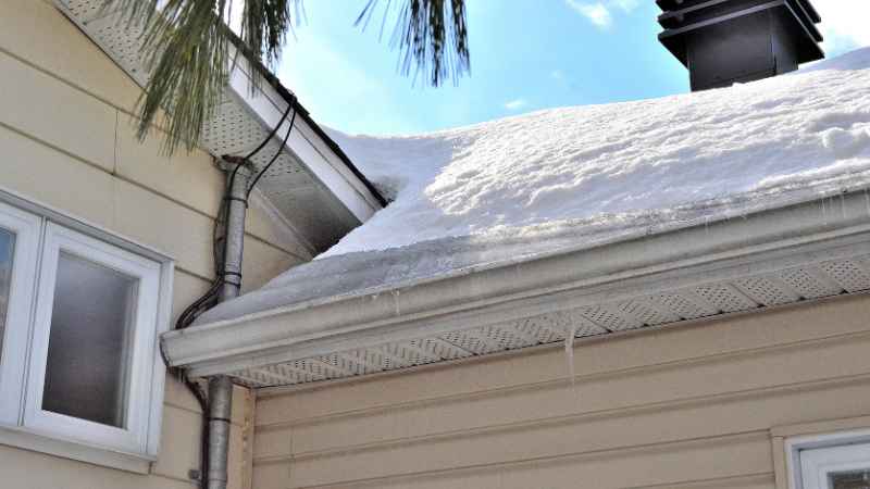 ice dam on residential roof in Oklahoma City during December causing roof leaks
