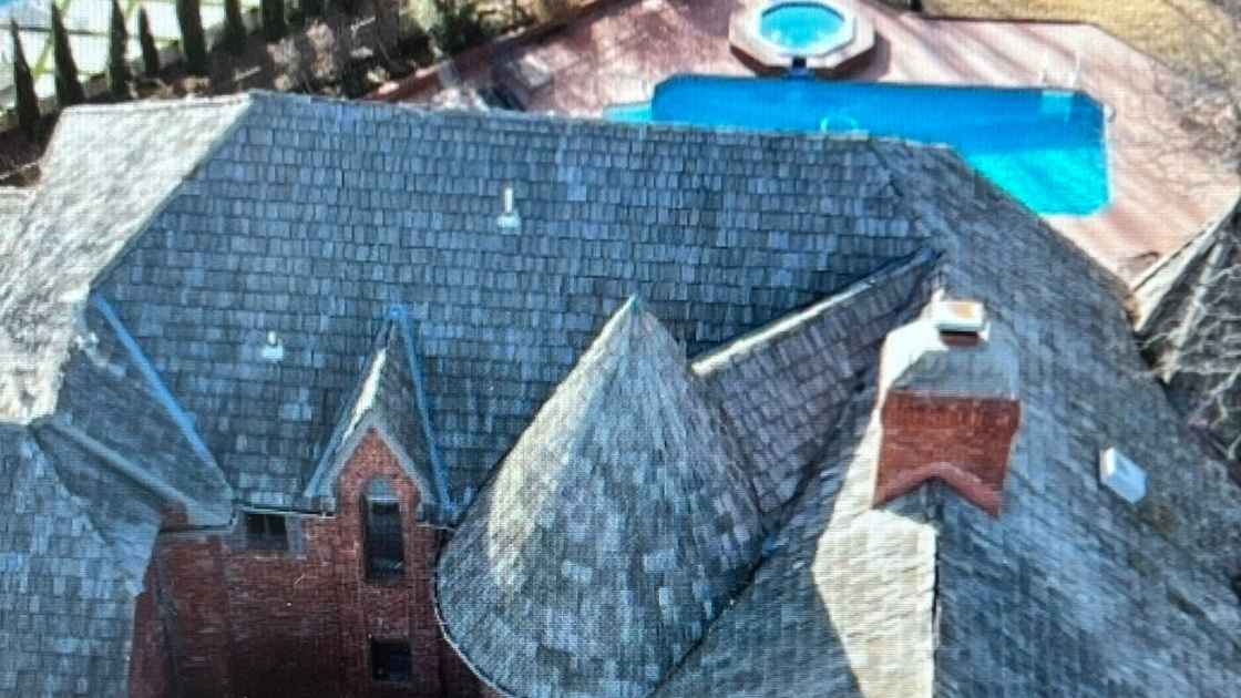 new roof in Oklahoma City showing installation of rubber shingles that can withstand two inch hail