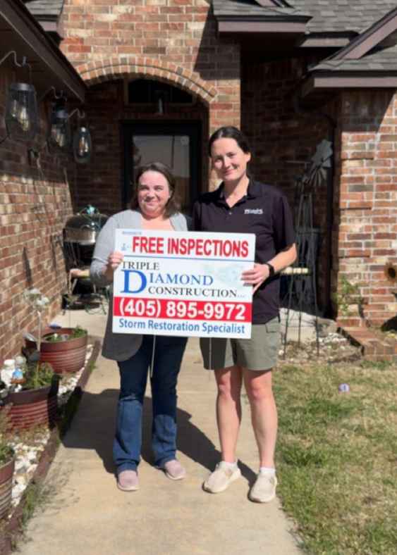 roofer norman ok standing with homeowner and yard sign after giving free roof inspection
