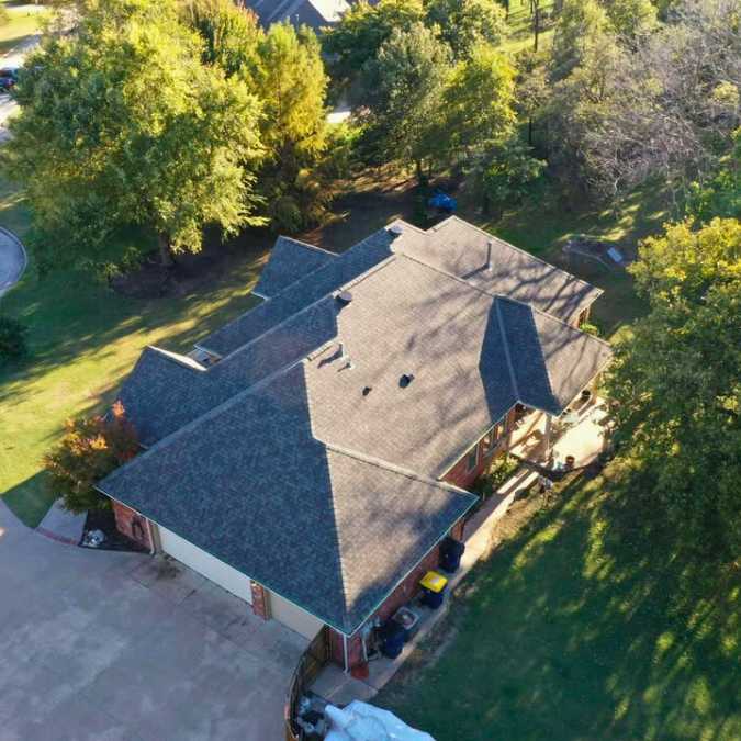 drone photo of new roof from above after storm damage repairs in Choctaw