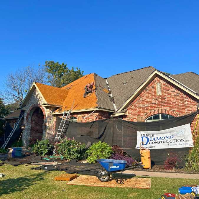 roofing crew removing old shingles to complete new roof installation on residential home in Choctaw, OK