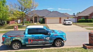 roofer and truck outside of residential home giving storm safety tips to homeowner before storm season in Oklahoma City