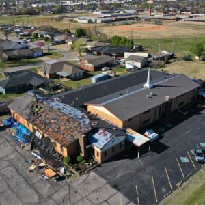 roofers tearing off old shingles from commercial building in Oklahoma City