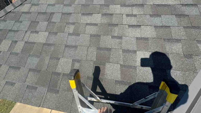 roofer climbing ladder to show owner what roof maintenance for new homeowners is needed on residential home