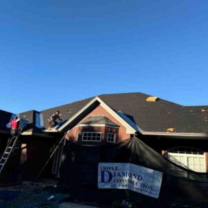 roofing company and crew installing new shingles on home in Harrah, OK