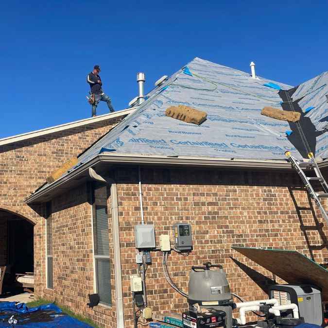 Photo shows roof decking and underlayment after old shingles have been removed as roofer gets ready to complete roof replacement project