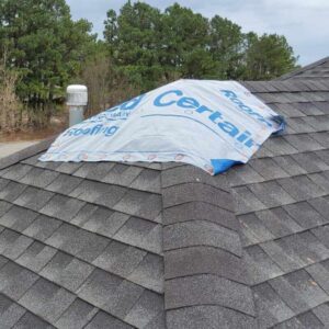 tarp added to cover hole in roof found during inspection that caused roof leak inside home