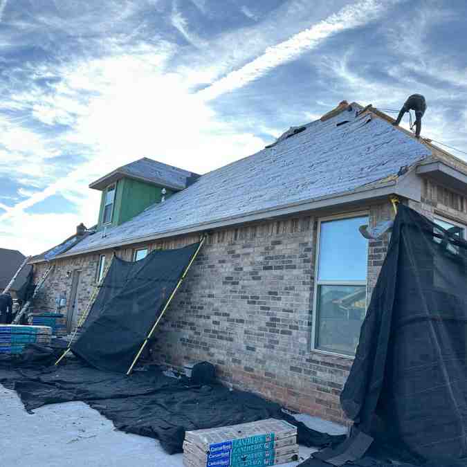 contractors on home removing old shingles to replace roof in Shawnee, OK