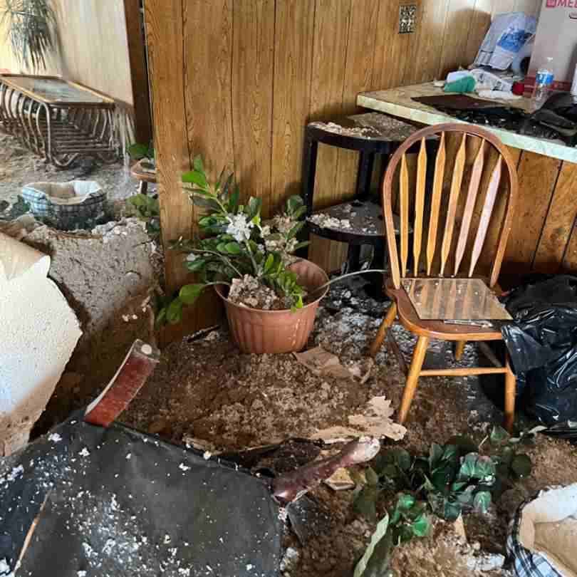 photo showing tornado damage repairs needed to living room of home