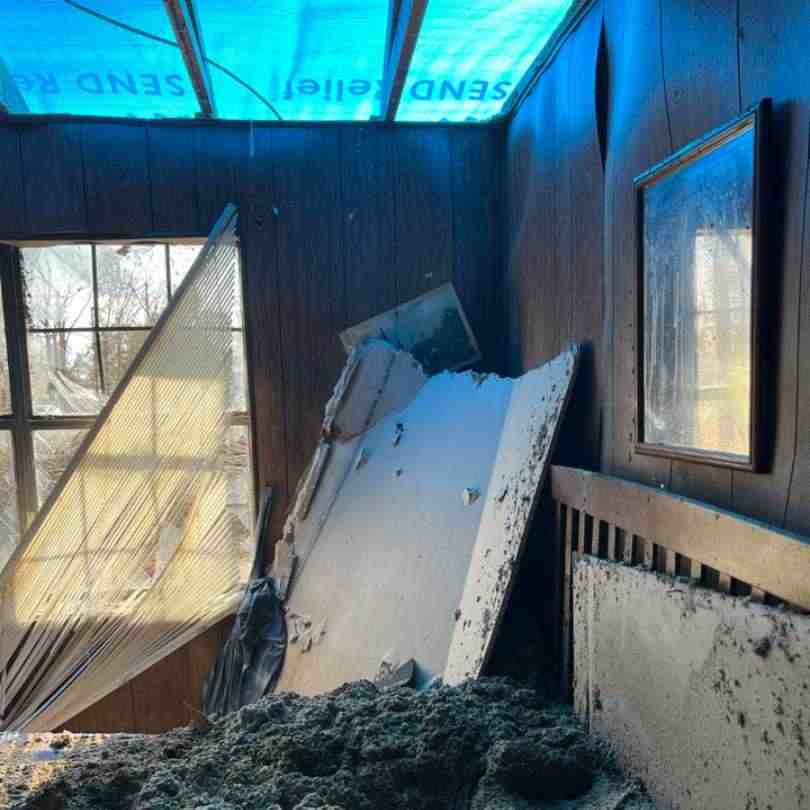 interior of home after storm showing roof and wall missing