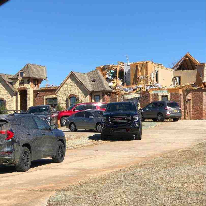 residential homes missing roofs after tornado went through Norman, OK neighborhood