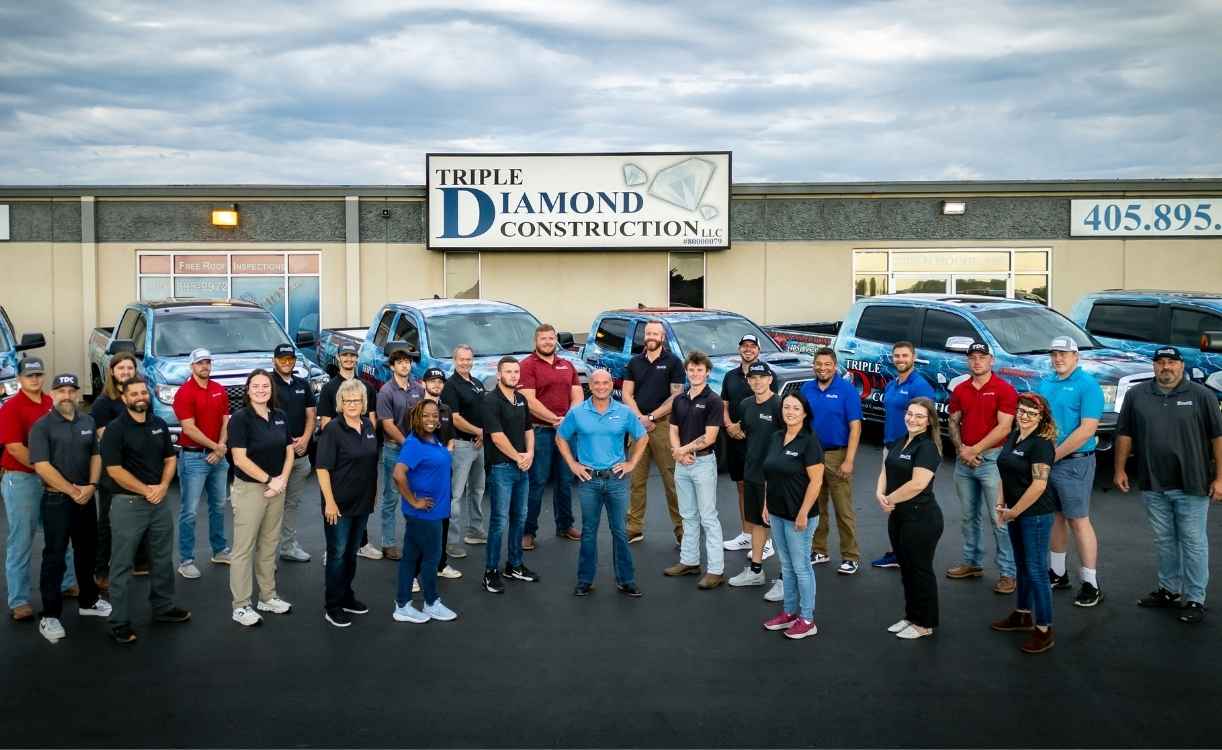 Triple Diamond Construction roofers in Norman team standing outside of company building