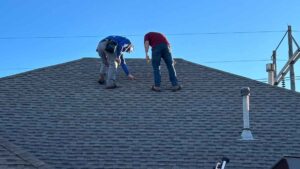 roofers inspecting home after homeowner waited to fix a roof leak