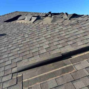 lifted shingles on residential roof after march 14 windstorm in edmond oklahoma